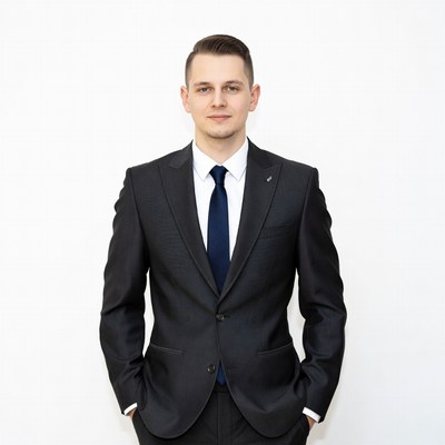 Man in suit with hands in pockets