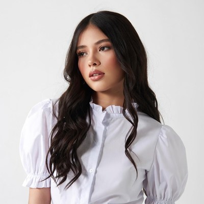 Asian woman in white ruffled blouse