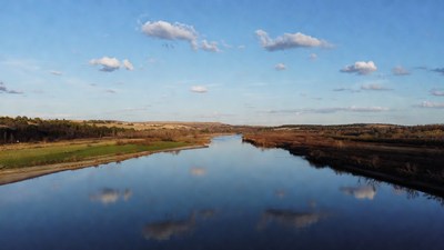 River flowing through autumn landscape