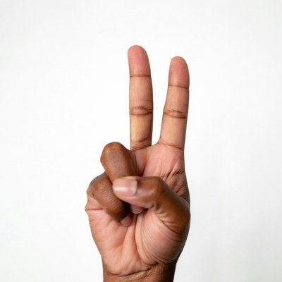 African-American hand making peace sign