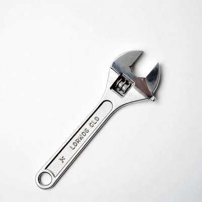 Silver adjustable wrench on white