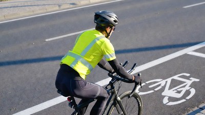 Man cycling in hi-vis vest on bike lane