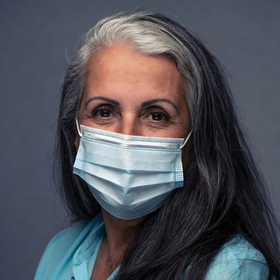 Elderly woman wearing blue face mask