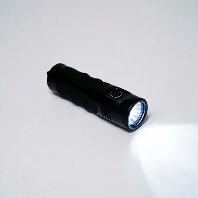 Black flashlight emitting bright beam