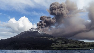 Volcano erupting with ash plume