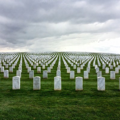 Rows of White Headstones in Cemetery