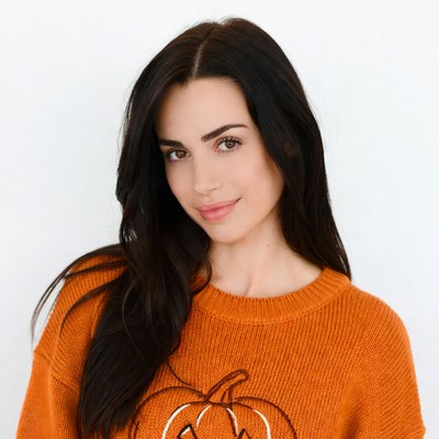 Woman in orange pumpkin sweater