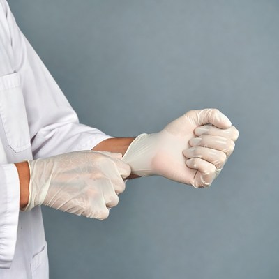Doctor putting on latex gloves