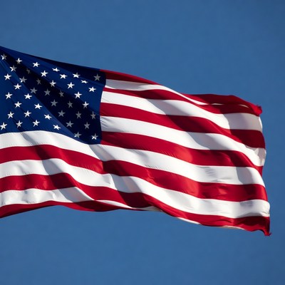 American Flag Waving in Blue Sky