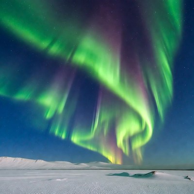 Vibrant Northern Lights over Snowy Landscape