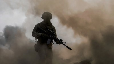 Soldier with rifle in smoke