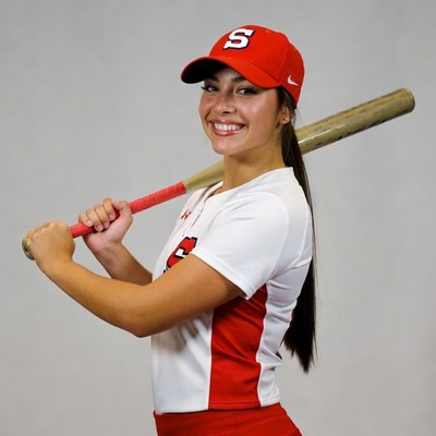 Girl holding baseball bat in uniform