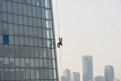 Man rappelling down skyscraper