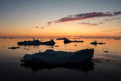 Icebergs in sunset ocean