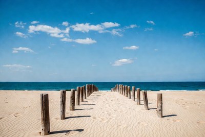 Wooden pier on sandy beach