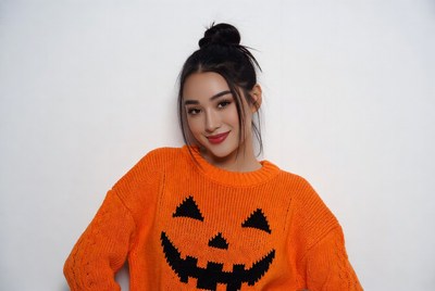 Asian woman in jack-o-lantern sweater
