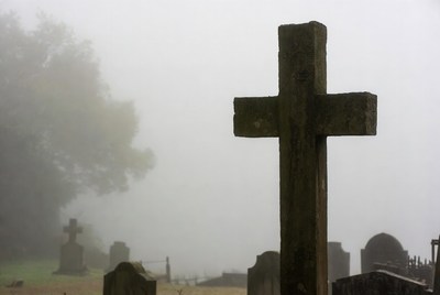 Foggy Cemetery with Stone Cross
