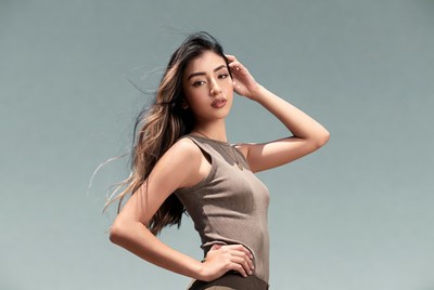 Asian woman hand on head posing