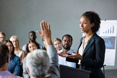 African-American woman speaking at business meeting