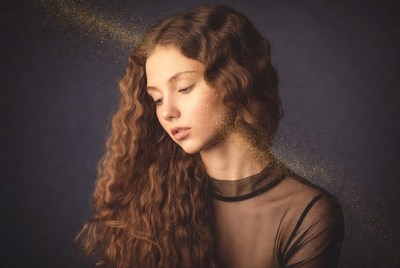 Curly-haired girl with golden sparkles
