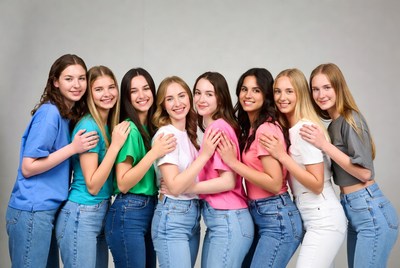 Group of young women hugging in colorful t-shirts