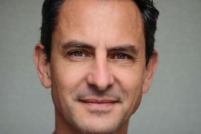 Man with dark hair smiling