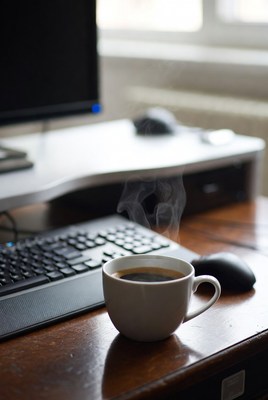 Coffee cup steaming on desk