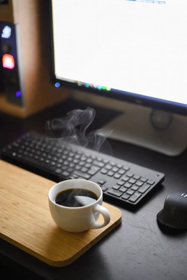 Coffee Cup Steaming on Desk