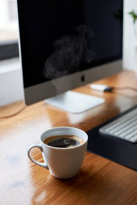 Steaming Coffee Cup on Desk