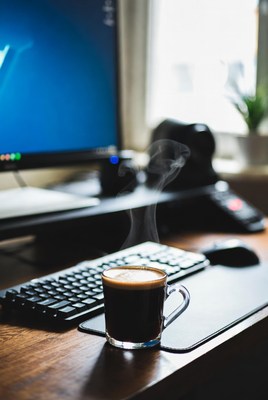 Coffee cup steaming on desk