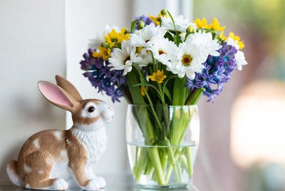 Bunny next to colorful flowers