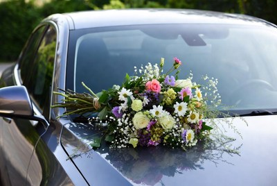 Colorful bouquet on car hood