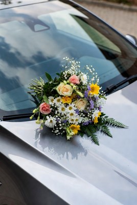 Colorful bouquet on car hood