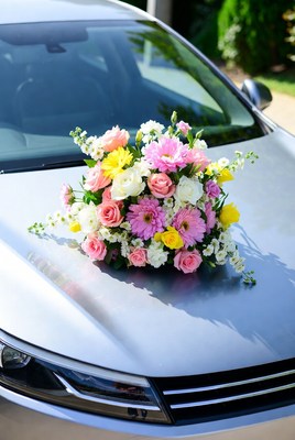 Colorful floral bouquet on silver car hood