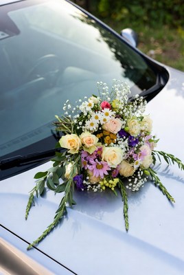 Wedding bouquet on silver car hood