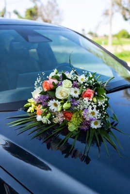 Colorful floral bouquet on car hood