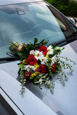 Colorful bouquet on car hood