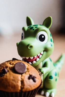 Green T-Rex Toy Eating Muffin