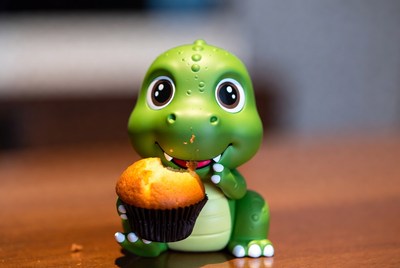 Cute green dinosaur eating muffin