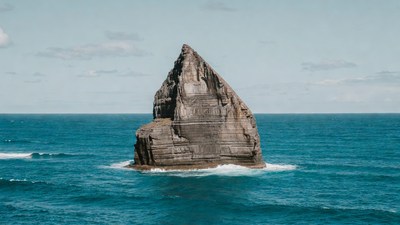 Tall rock formation in ocean