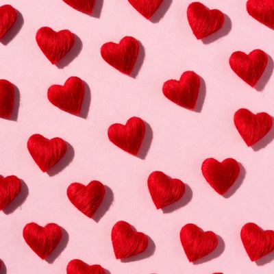Red Felt Hearts on Pink Background