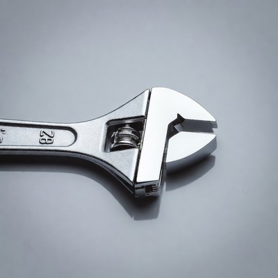 Adjustable Wrench on Gray Background