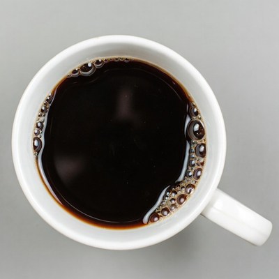 Top view of black coffee in white mug