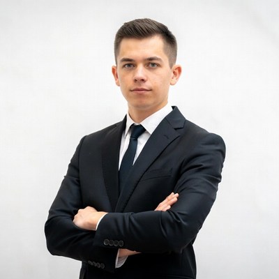 Young man in suit with arms crossed
