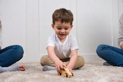 Boy playing with wooden toy car