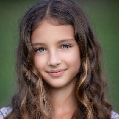 Smiling girl with wavy brown hair