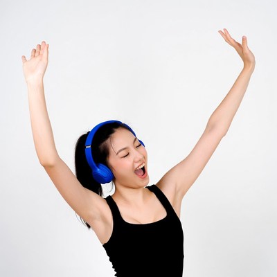 Asian woman dancing with blue headphones