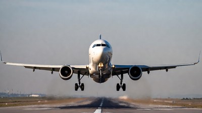 White Airplane Landing on Runway