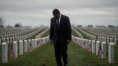 Man in Suit Walking Through Cemetery