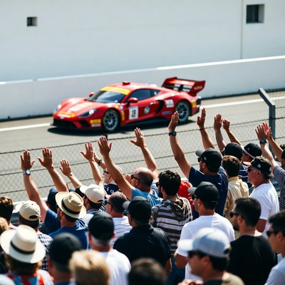 Crowd cheering red race car